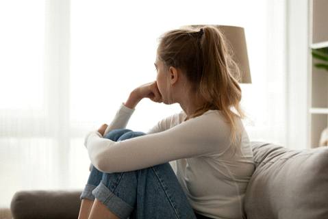 woman with separation anxiety in relationship, sitting down, pausing and breathing