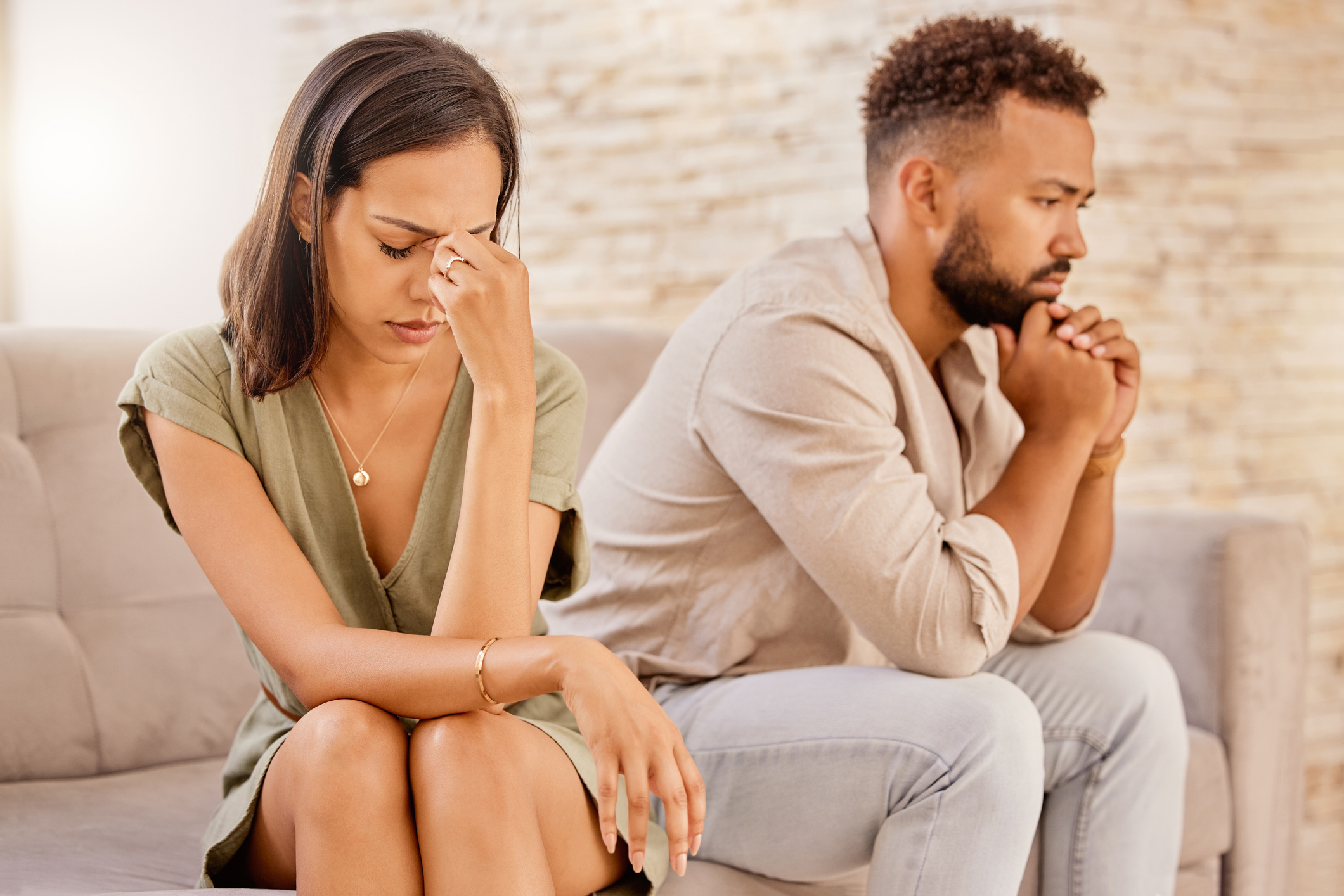couple sitting next to each other looking away after betrayal