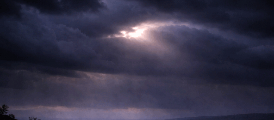 clouded storm light shining through overhead