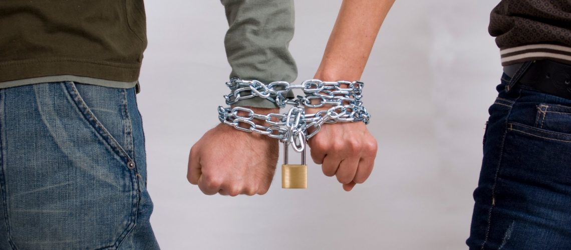couple enmeshed relationship chained together by wrist