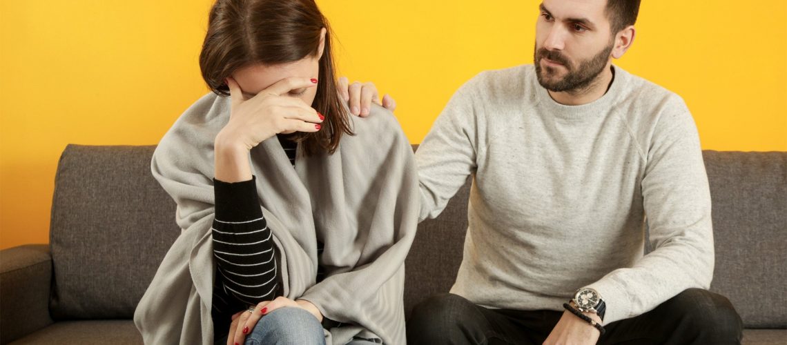 Man comforting sad girl couple enmeshment trauma